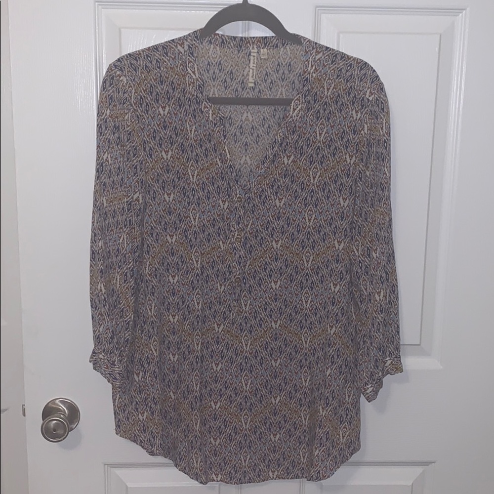 Blue, tan, white patterned blouse